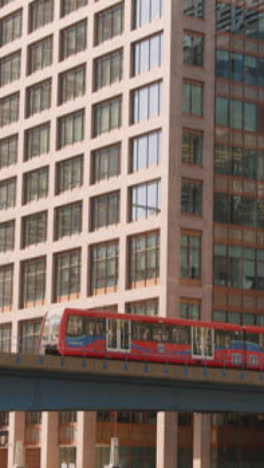 Vertical-Video-Of-Modern-Offices-And-DLR-Train-In-London-Docklands-UK